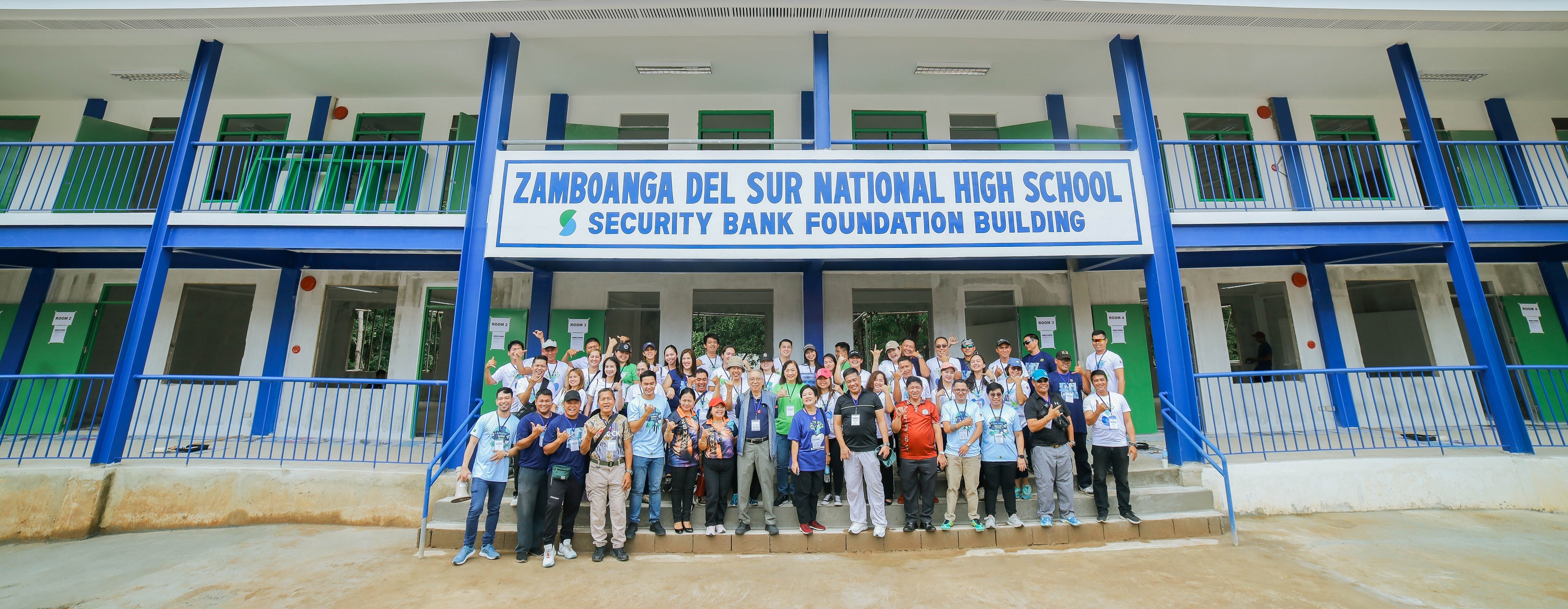 Security Bank workers paint donated classrooms