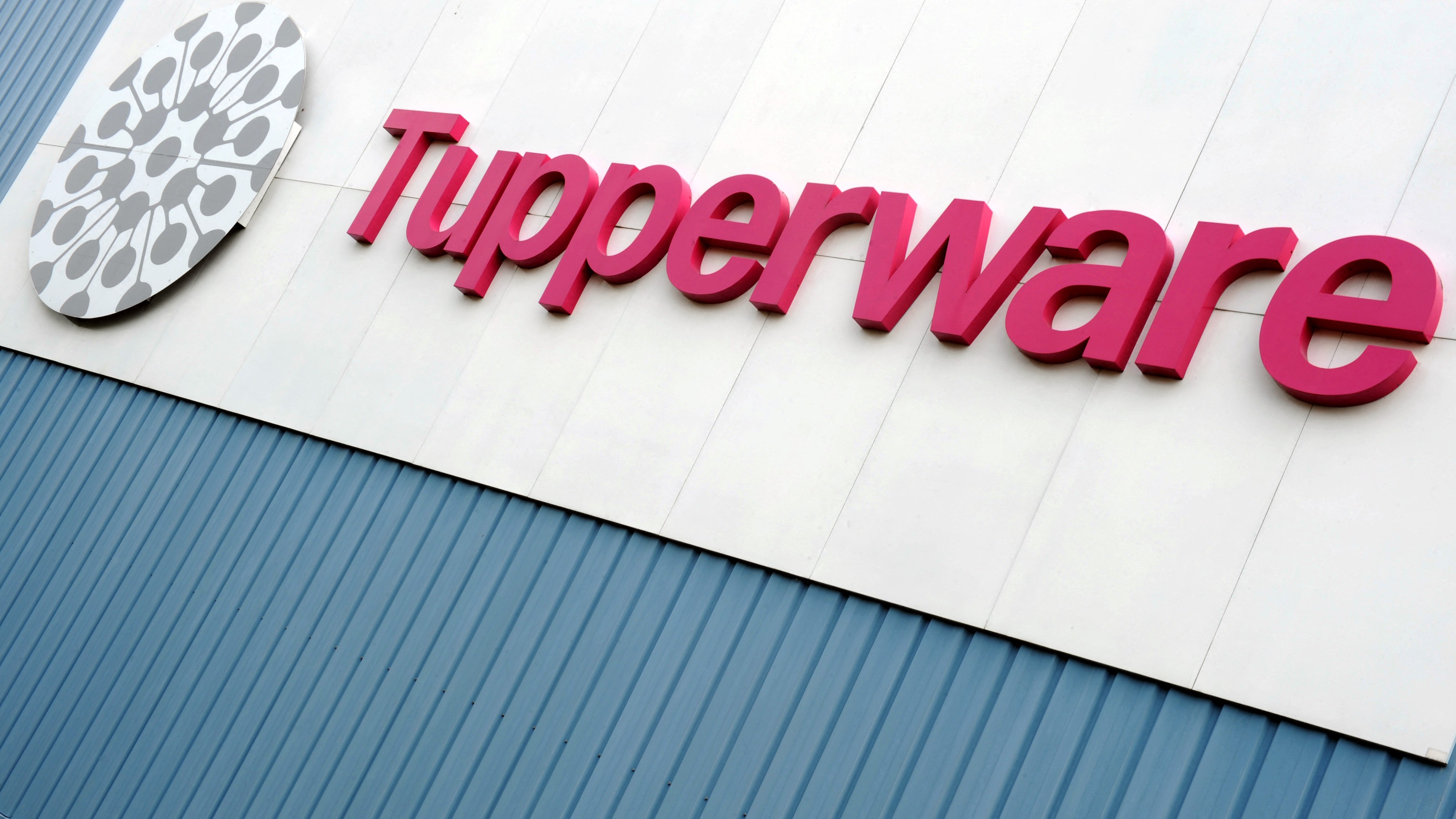 (FILES) Picture taken on 27 August 2013 shows the Tupperware Brands Corporation logo at the factory entrance in Joue-les-Tours, center France, on the day of its 40th anniversary.