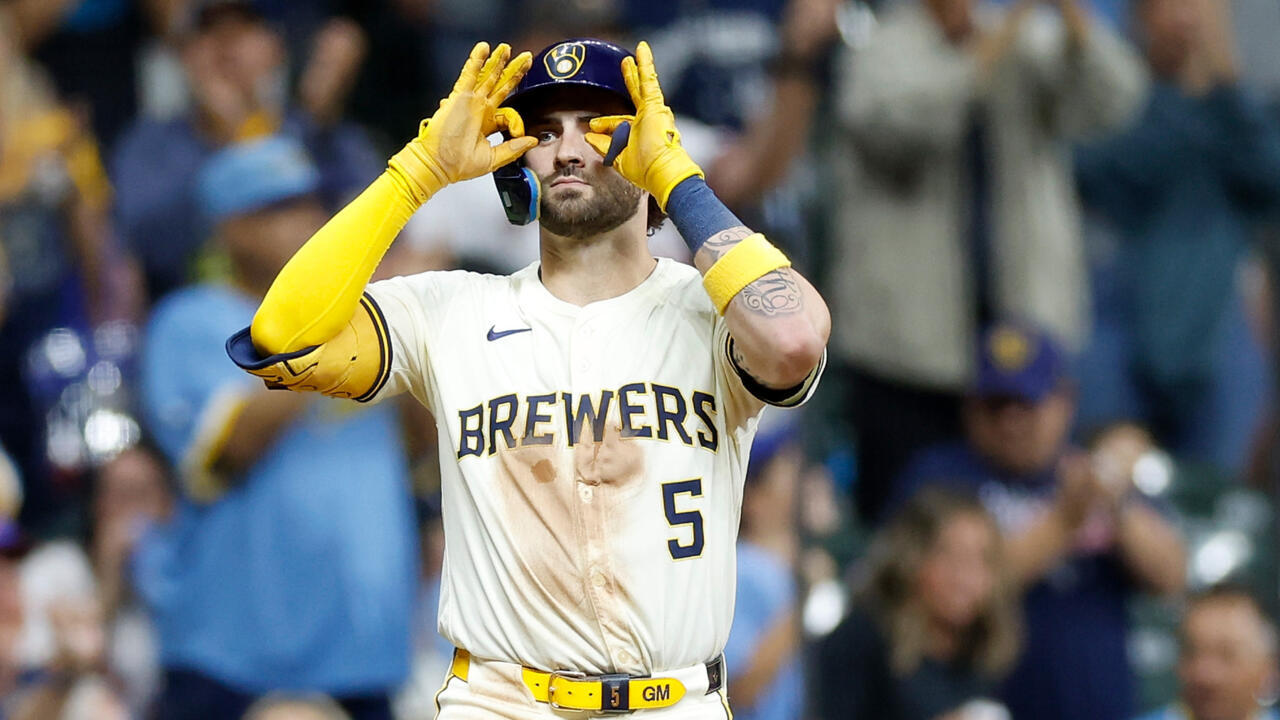 Garrett Mitchell of the Milwaukee Brewers reacts after hitting a run scoring triple in a game against the Philadelphia Phillies
