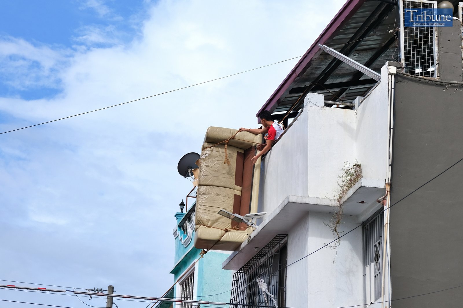 Sofa hanging from a house
