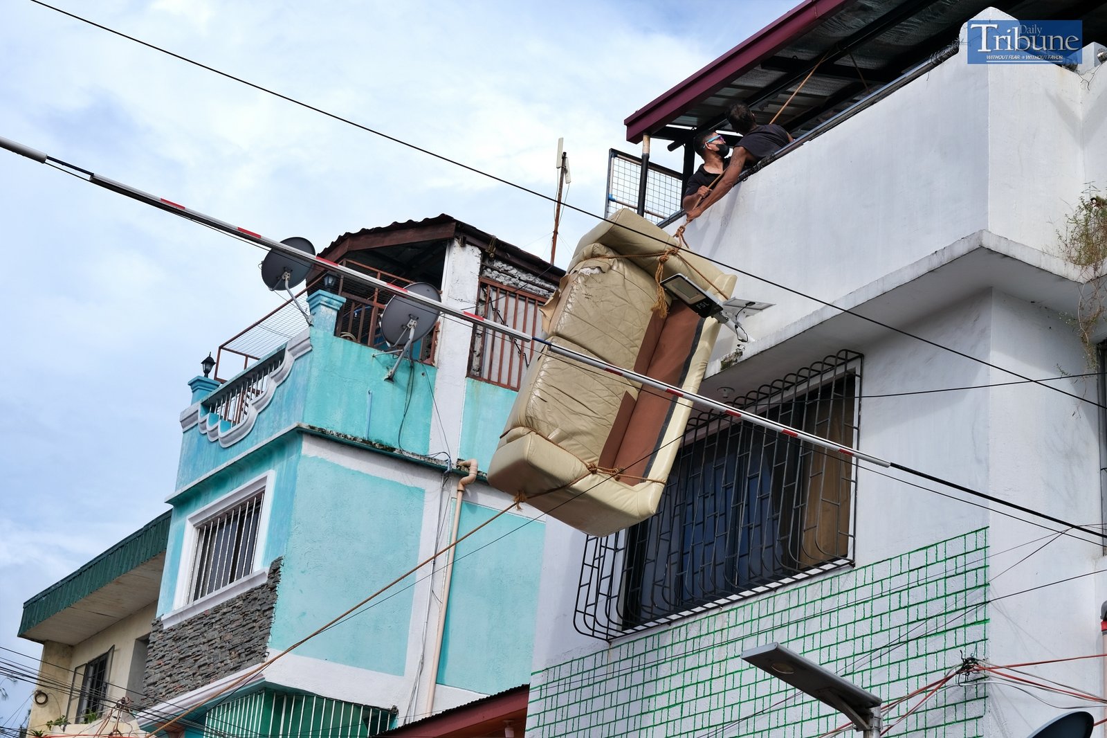 Sofa hanging from a house