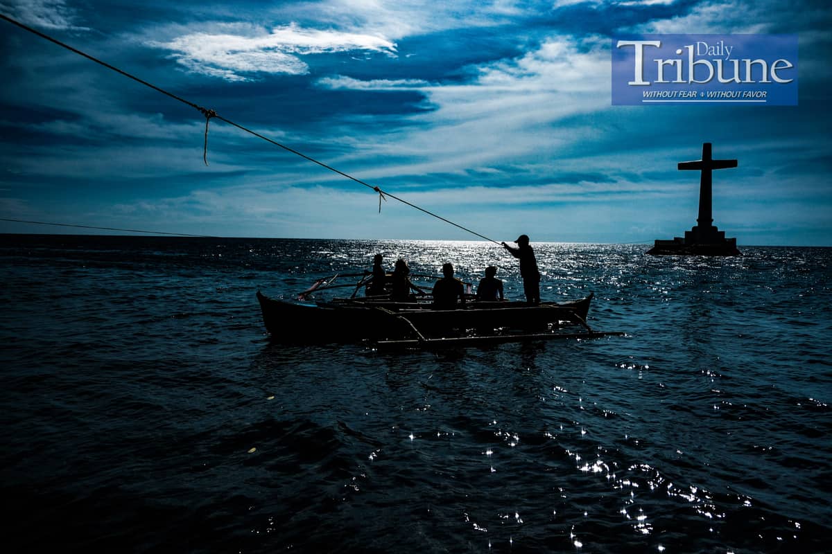 A boatman transporting tourists to the large cross of the Sunken Cemetery on 21 September 2024.