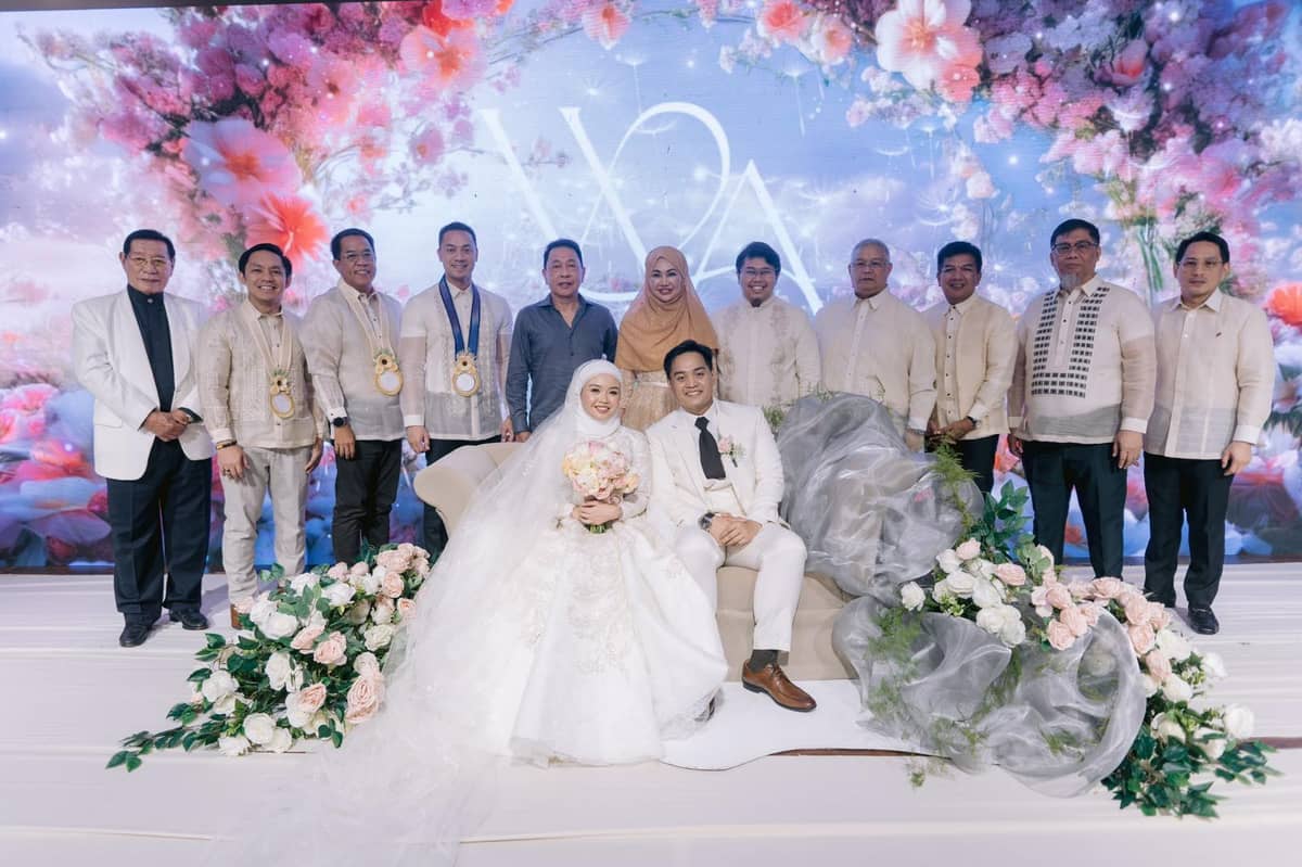 The newlywed couple with their principal sponsors.