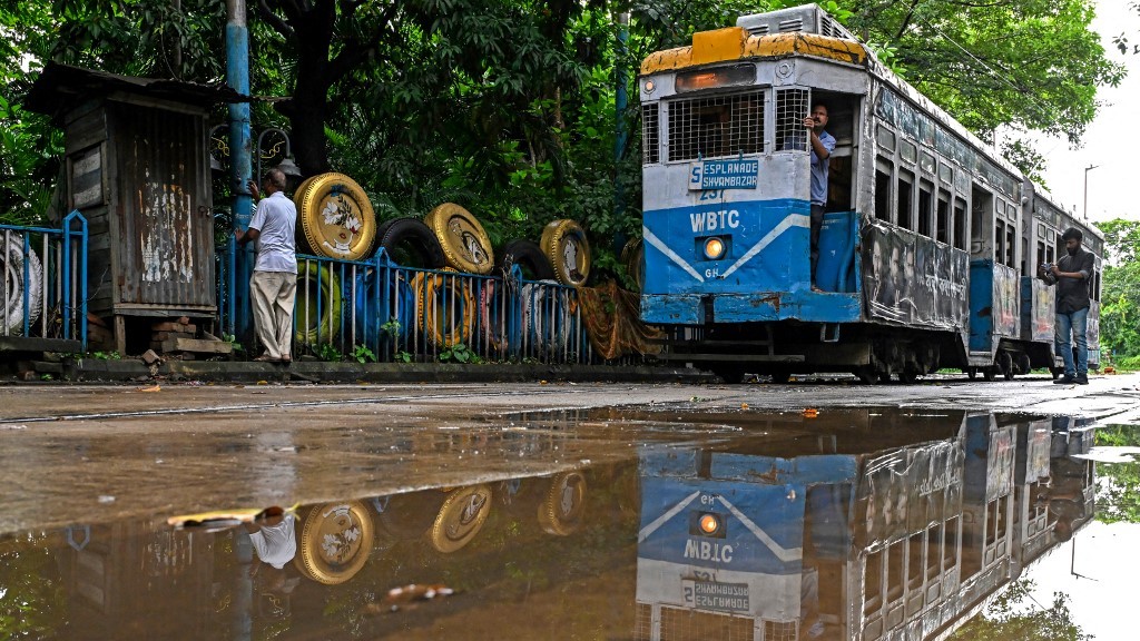 (FILES) In this photo taken on 8 September 2024, a tram is pictured at its depot in Kolkata. Introduced in the sprawling eastern city in 1873 during the early days of the imperial British Raj, trams in Kolkata were initially horse-drawn, then steam-driven. Electric-powered trams took to the streets in 1900. The single-story trams -- painted in uniform stripes of bright blue and white, with a sunshine yellow top -- trundle at best at around 20 kilometers (12 miles) per hour, if not snarled in traffic blocking its route.