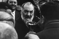 Father Pio walking among the faithful.