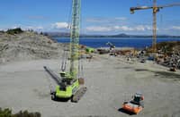 (FILES) A photo taken on 21 June 2021 in Oygarden near Bergen, Norway, shows cranes and vehicles at a construction site at the start of construction work for a terminal that will collect liquefied carbon dioxide CO2, which will arrive by ship from industrial facilities in Europe and will run through a pipeline into geological formations deep beneath the sea bed so that it doesn't contribute to global warming. On the icy shores of the North Sea, a "graveyard" is raising the hopes of climate experts: soon, the site will house a -- small -- portion of the CO2 emitted by European industry, preventing it from ending up in the atmosphere.