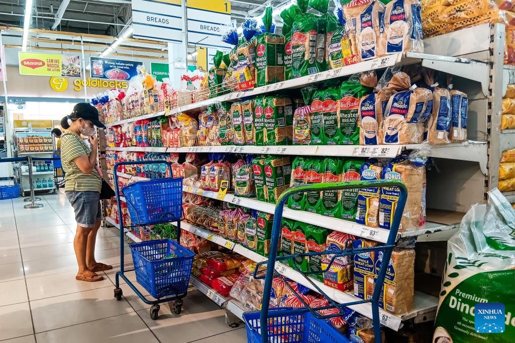 A customer buys bread at a supermarket in Quezon City. Asia and the Pacific still faces challenges but remains resilient, according to an updated Asian Development Bank report.