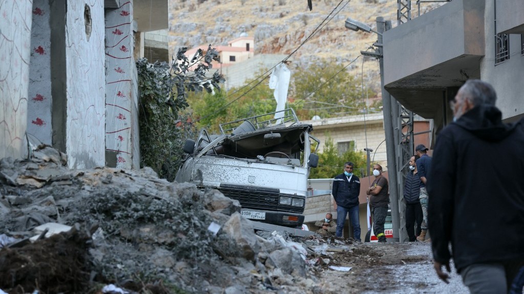 People check the destruction following an overnight Israeli airstrike in the southern Lebanese village of Shebaa near the border between the two countries on 27 September 2024.