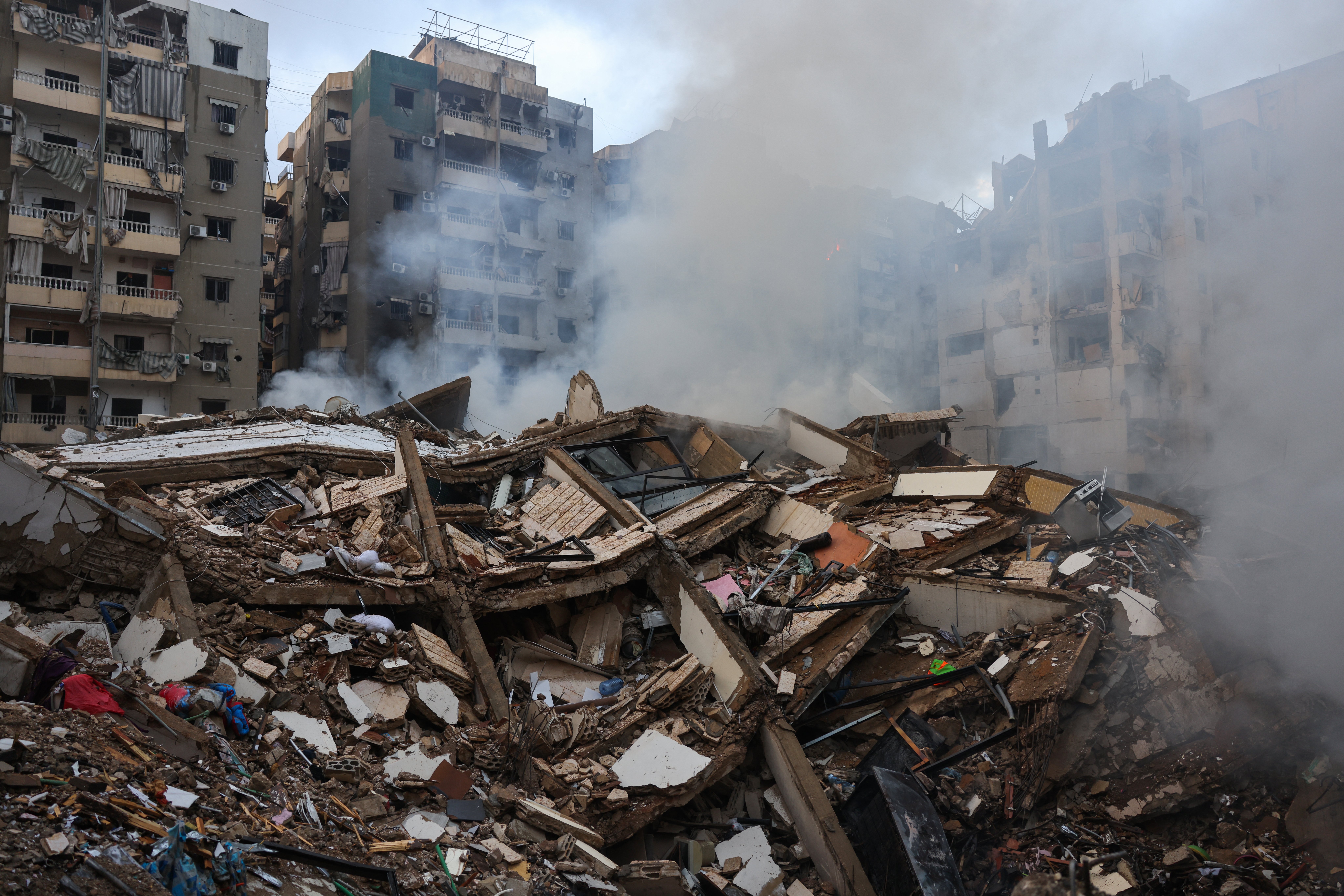 SMOKE seeps out from building rubble at the site of an overnight Israeli airstrike on the Laylaki neighborhood in Beirut’s southern suburbs on 1 October 2024.