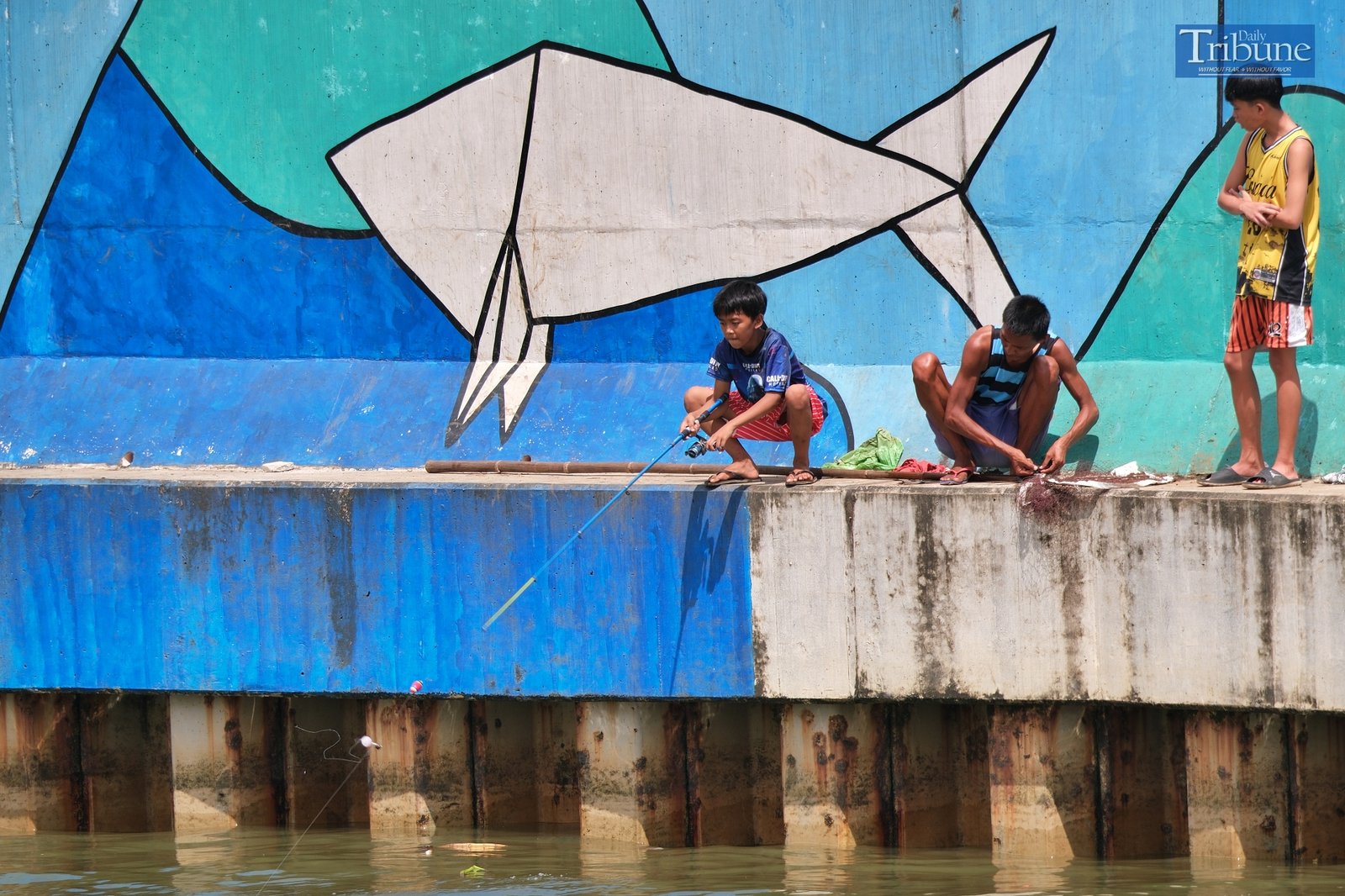 People fishing at the Pasig River