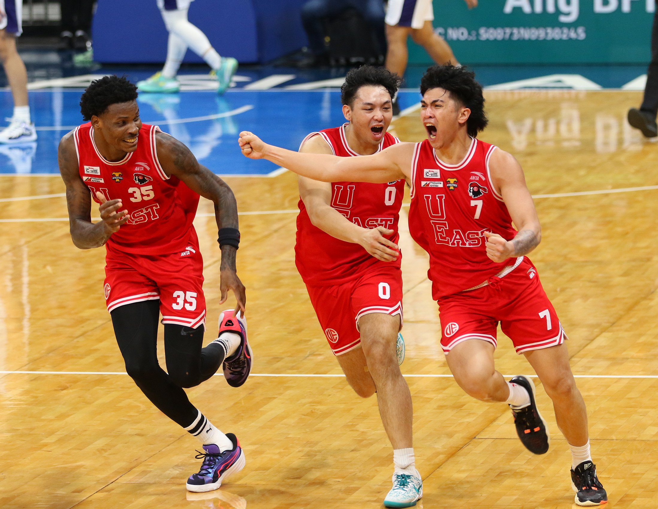 Wello Lingolingo (No. 7) and the UE Red Warriors celebrate their 63-62 win over Adamson University on Sunday in their UAAP Season 87 men’s basketball game at the Mall of Asia Arena.