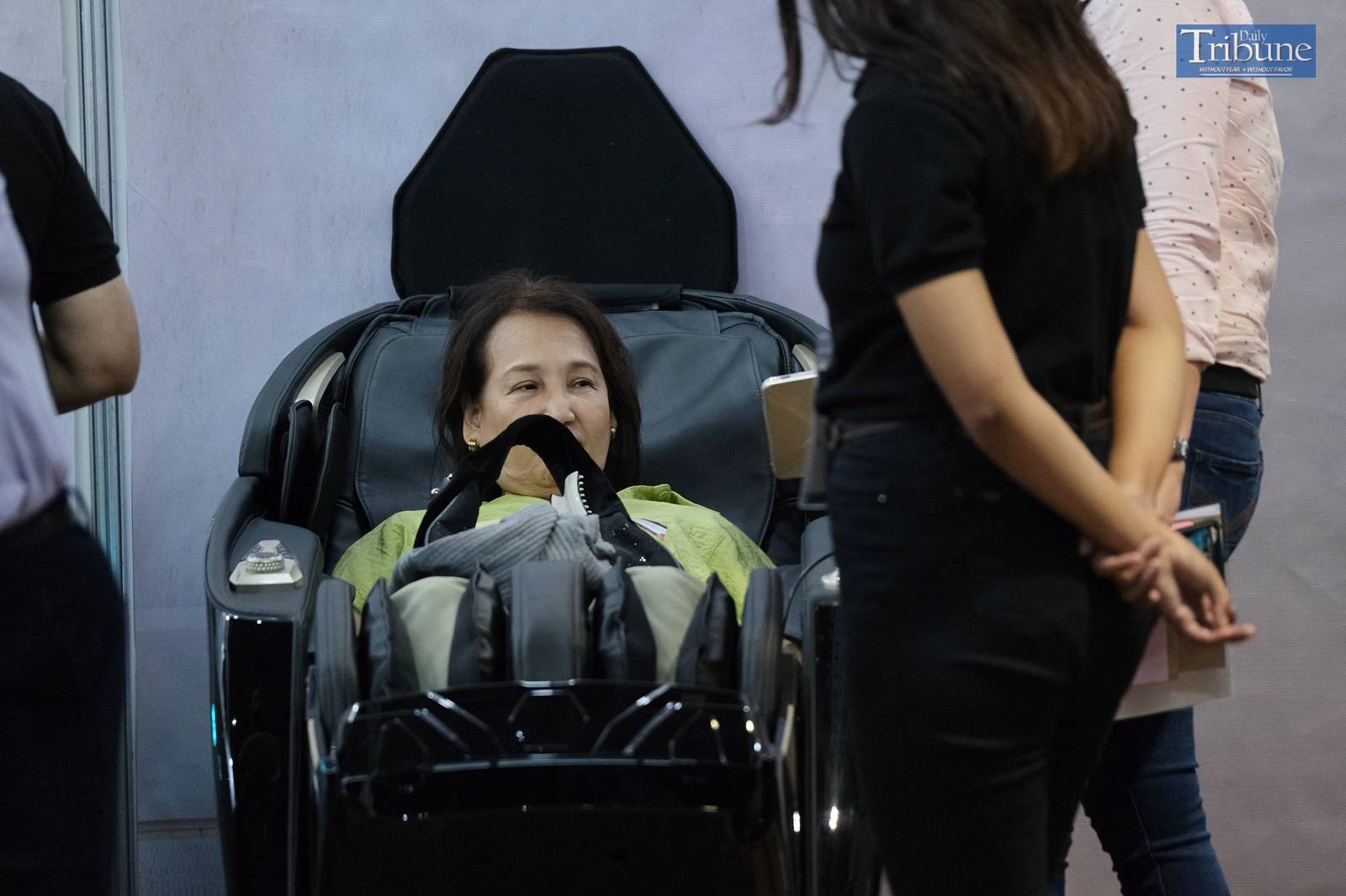 Potential customer trying out massage chair