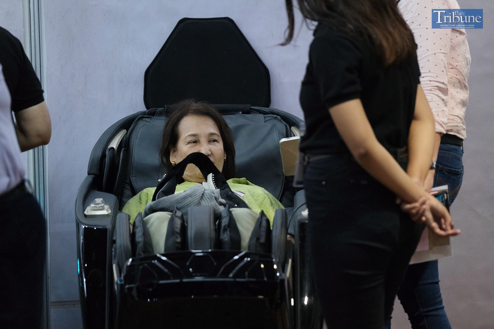 Potential customer trying out massage chair