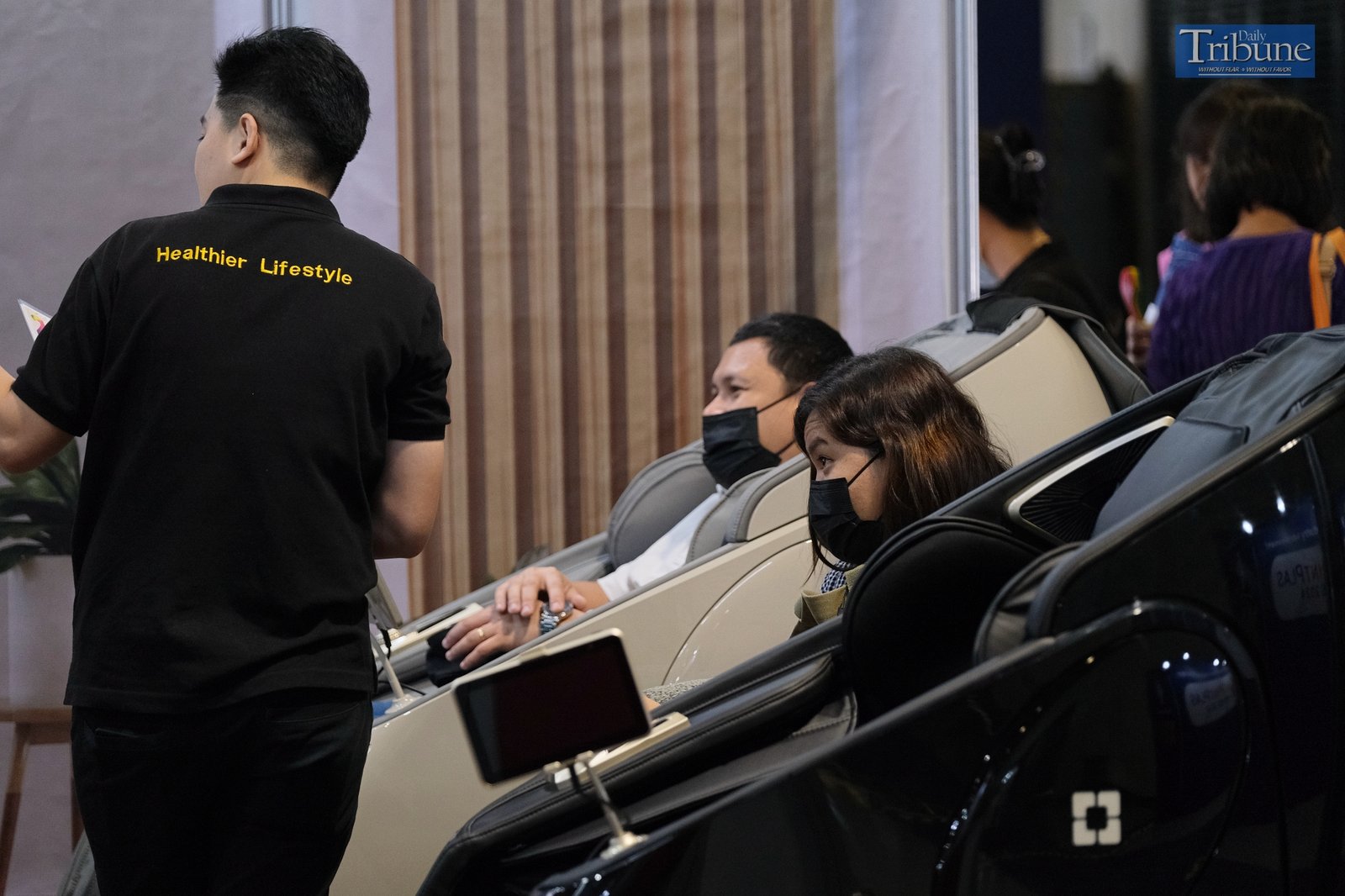 Potential customer trying out massage chair
