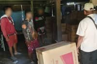 Law enforcement officers in Palawan conduct an inventory of the smuggled cigarettes in a warehouse in Brooke's Point town, southern Palawan.