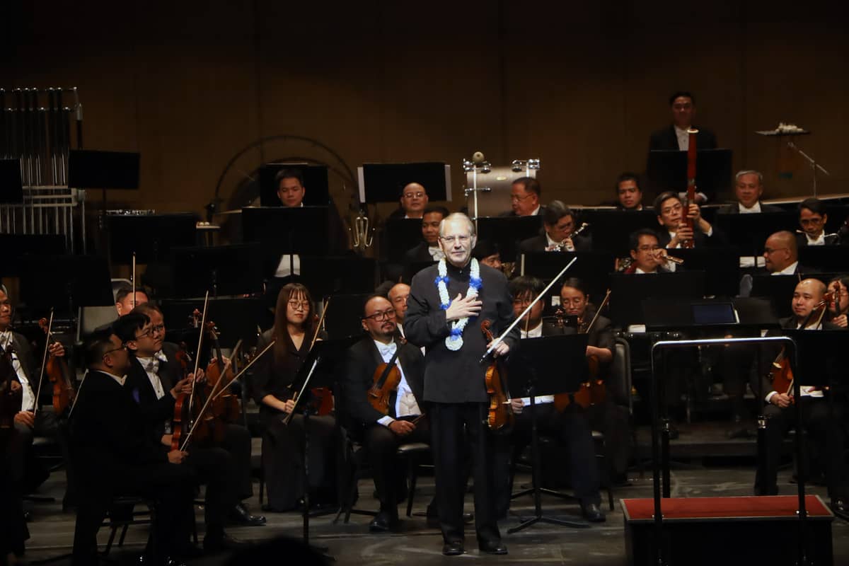 The violinist acknowledges the audience’s cheers and applause.