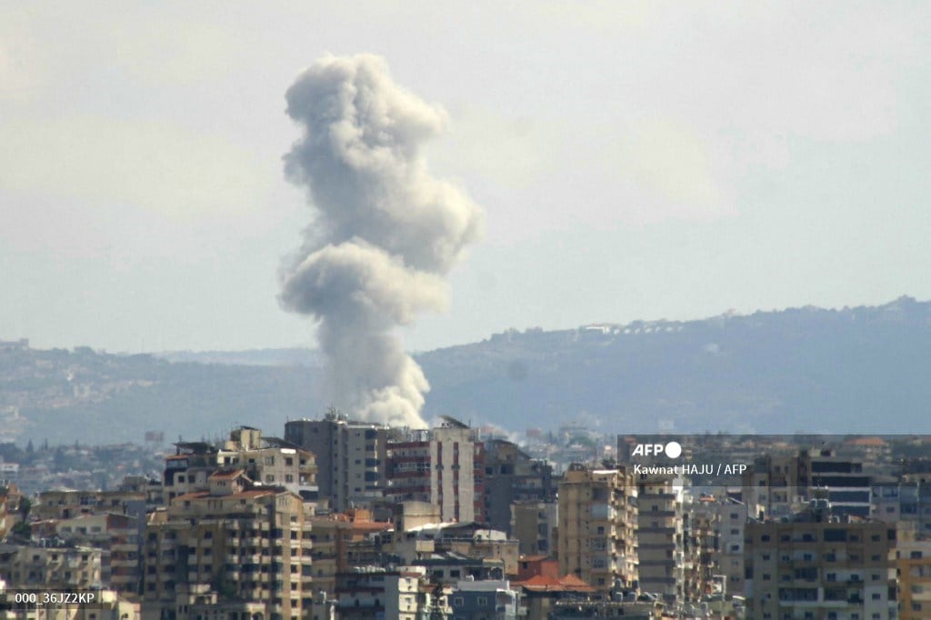 A picture taken from the southern Lebanese city of Tyre shows smoke rising from the site of an Israeli strike targeting the village of Qana on October 12, 2024.
Kawnat HAJU / AFP