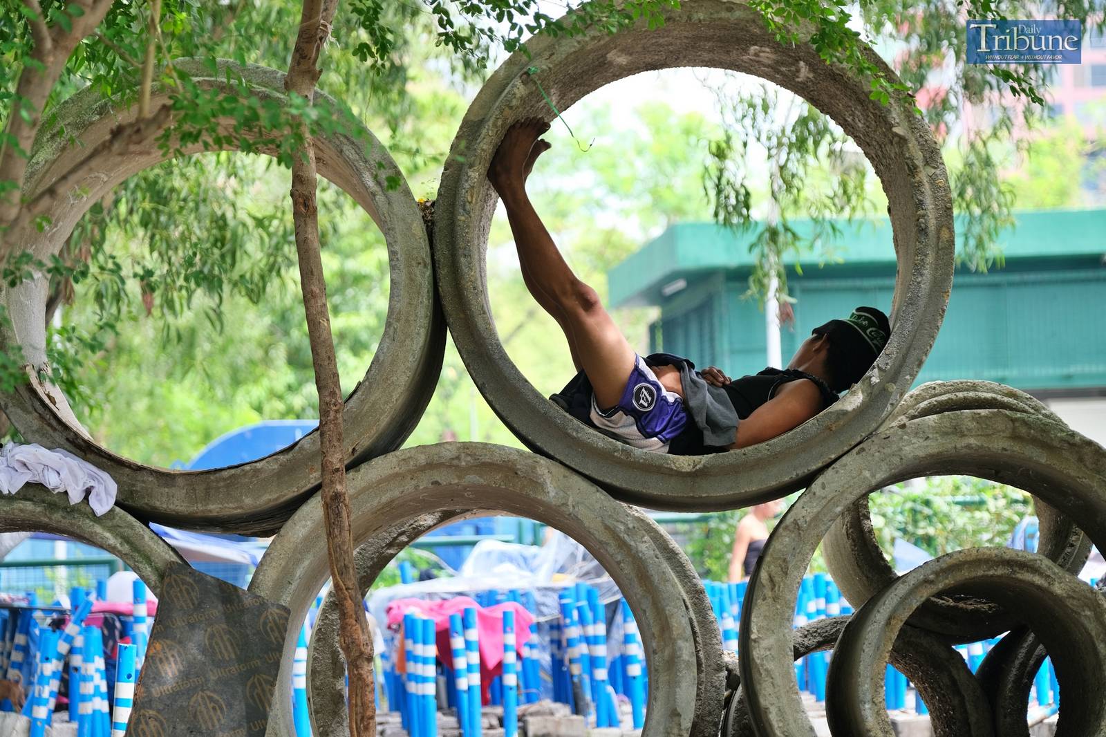 A man using a culvert for a bed.