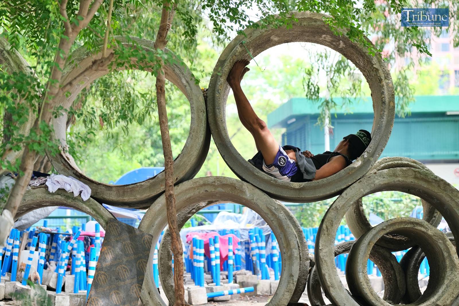 A man using a culvert for a bed.