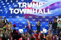 Former US President and Republican presidential candidate Donald Trump, with moderator and South Dakota Governor Kristi Noem (right), arrives for a town hall at the Greater Philadelphia Expo Center and Fairgrounds in Oaks, Pennsylvania, on October 14, 2024.