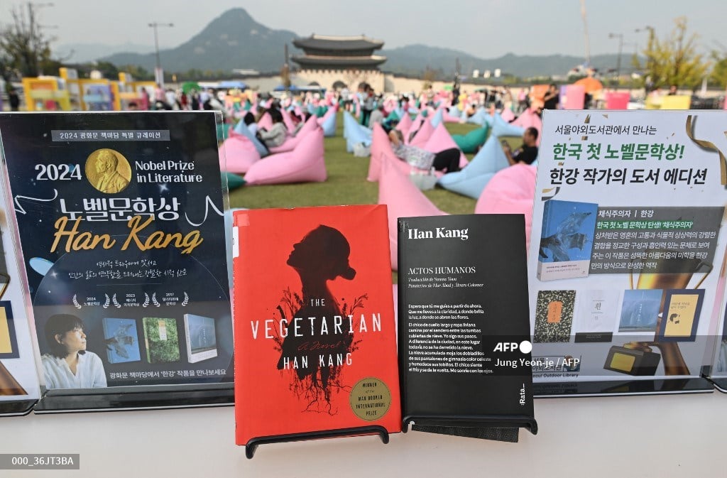 Books by South Korean author Han Kang, who won the 2024 Nobel Prize in Literature, are displayed during an outdoor library event at Gwanghwamun Square in central Seoul on October 11, 2024. From the president to K-pop megastars BTS, South Korea erupted into celebration on October 10, after "The Vegetarian" author Han Kang won the country's first Nobel Prize for literature.