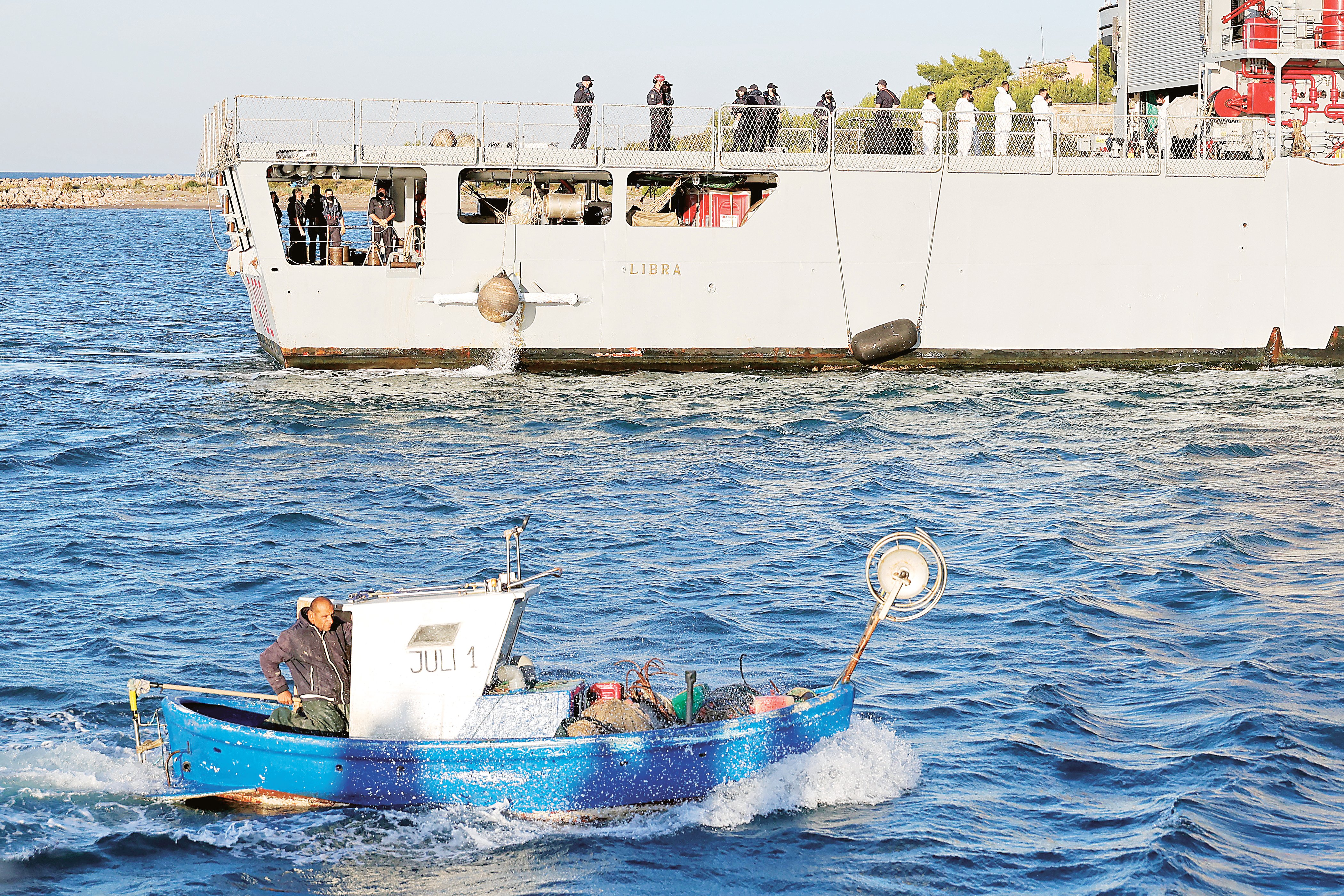 Italian navy brings first migrants to Albania center
