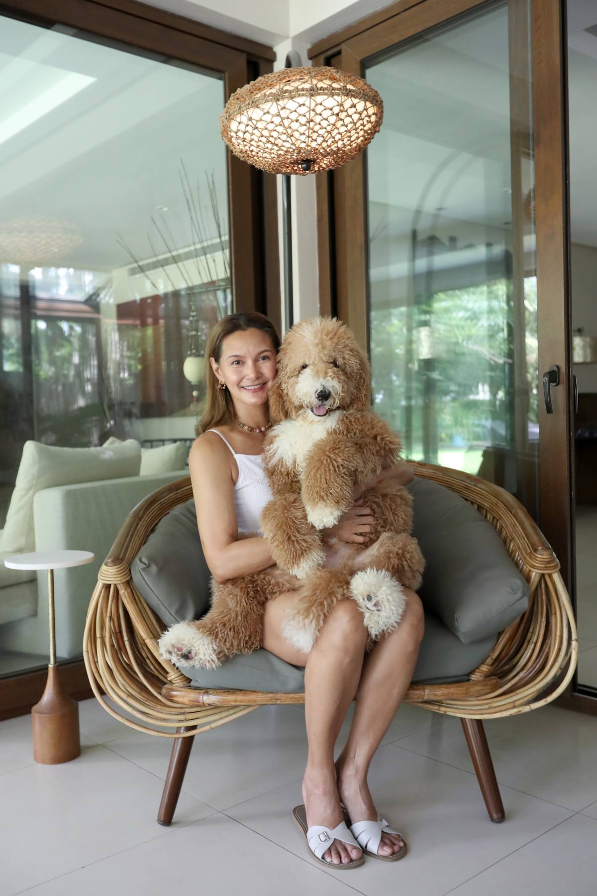 Lap dog: Tweetie de Leon- Gonzalez offers her lap to Whiskey, the Giant Poodle.