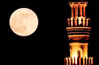 Mesmerizing The Hunter’s Full Moon rises behind the minaret of a mosque in Doha on 17 October 2024.