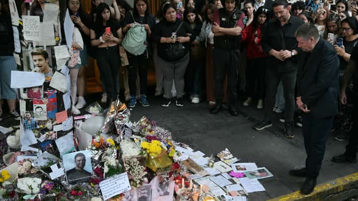 LOOK: Geoff Payne (R), the father of One Direction pop singer Liam Payne, looks at the place where fans paid tribute to his late son outside the CasaSur Hotel in Buenos Aires on 18 October 2024. The father of One Direction pop singer Liam Payne, whose death in a fall from a hotel balcony in Buenos Aires shocked the music world, arrived in Argentina on Friday, police sources told AFP. The singer suffered "multiple traumas" and "internal and external hemorrhaging" after falling from the balcony of his room on the third floor of the Casa Sur hotel in central Buenos Aires on Wednesday night, an autopsy found. | Photo courtesy of JUAN MABROMATA / AFP