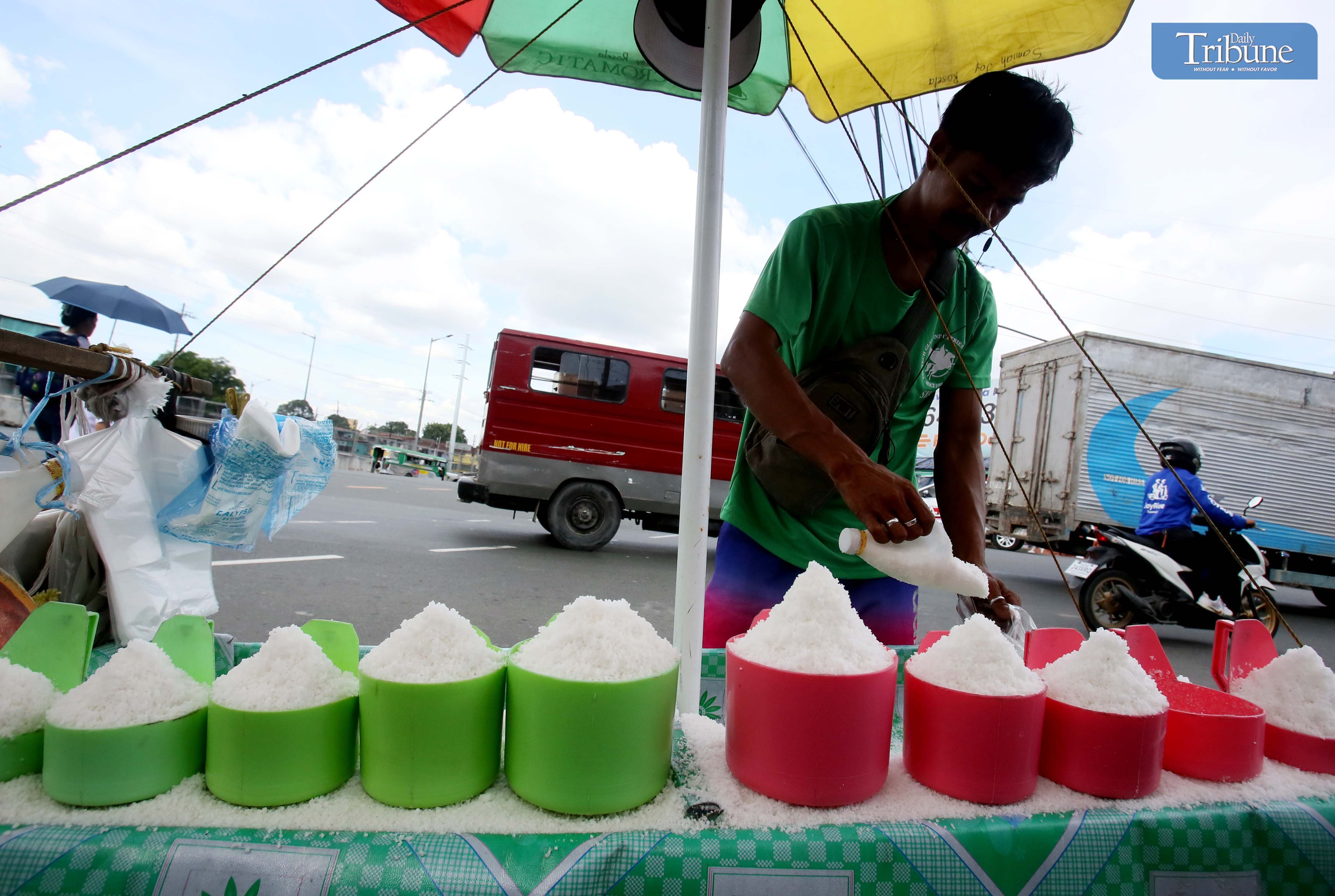 A salt vendor attends to a customer at the Commonwealth Market in Quezon City.