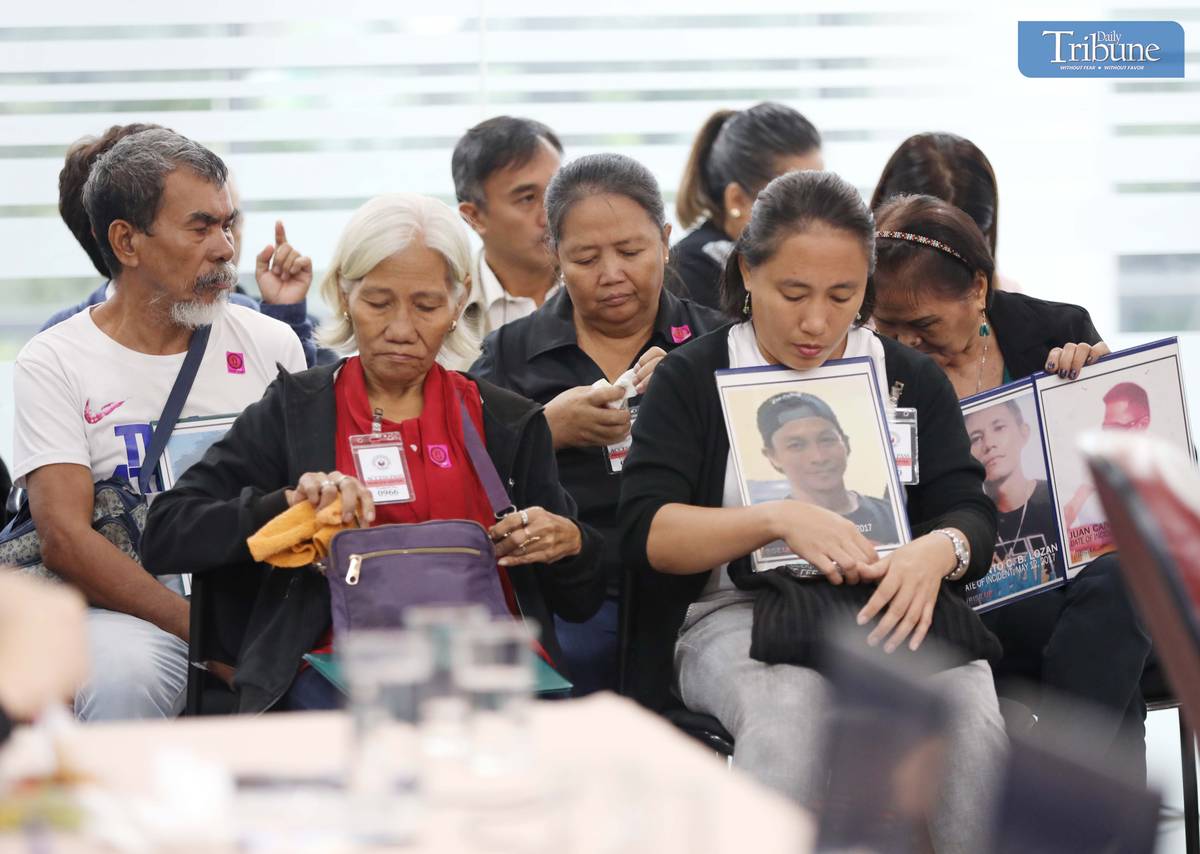 Families of drug war victims at Quad Comm hearing.