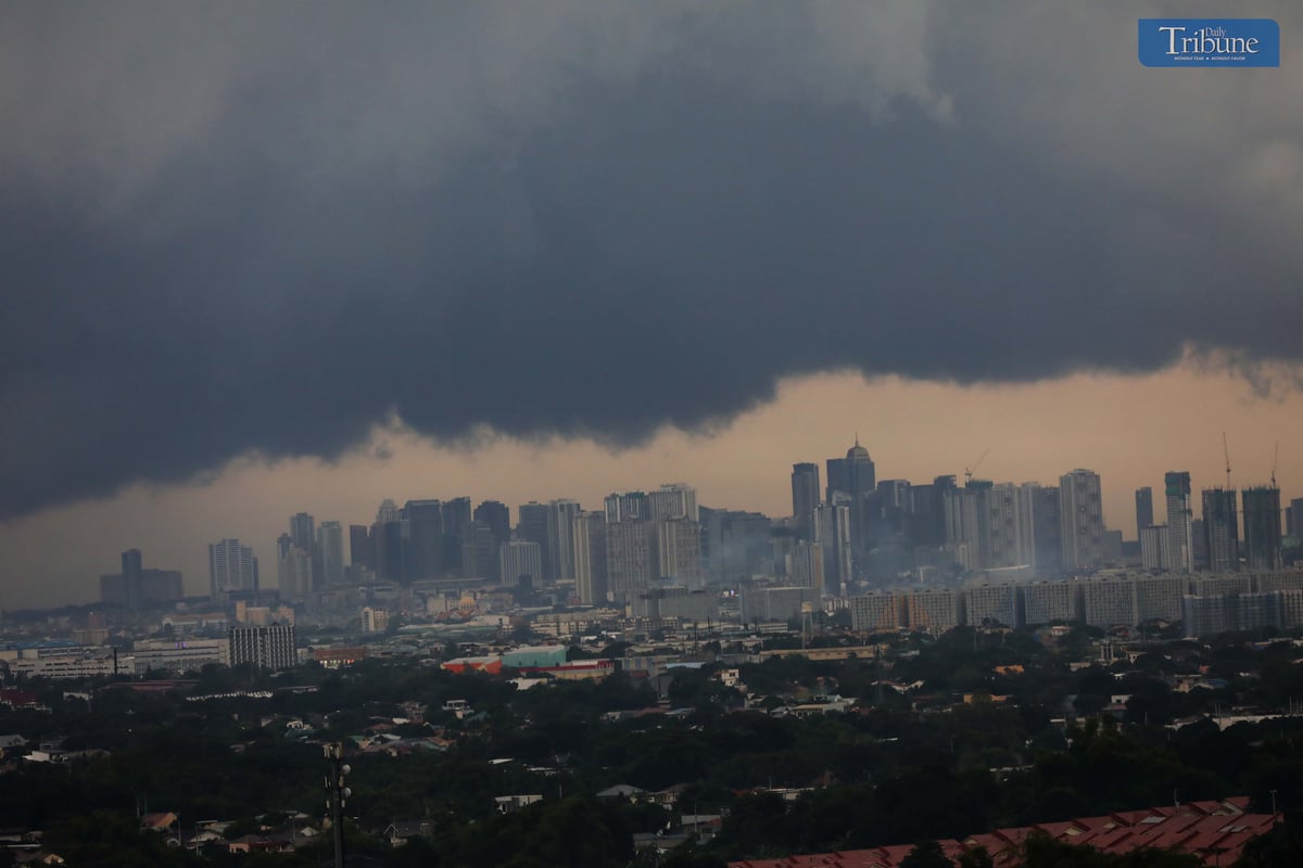 Dark clouds cover Metro Manila ahead of Tropical Depression Kristine's landfall.