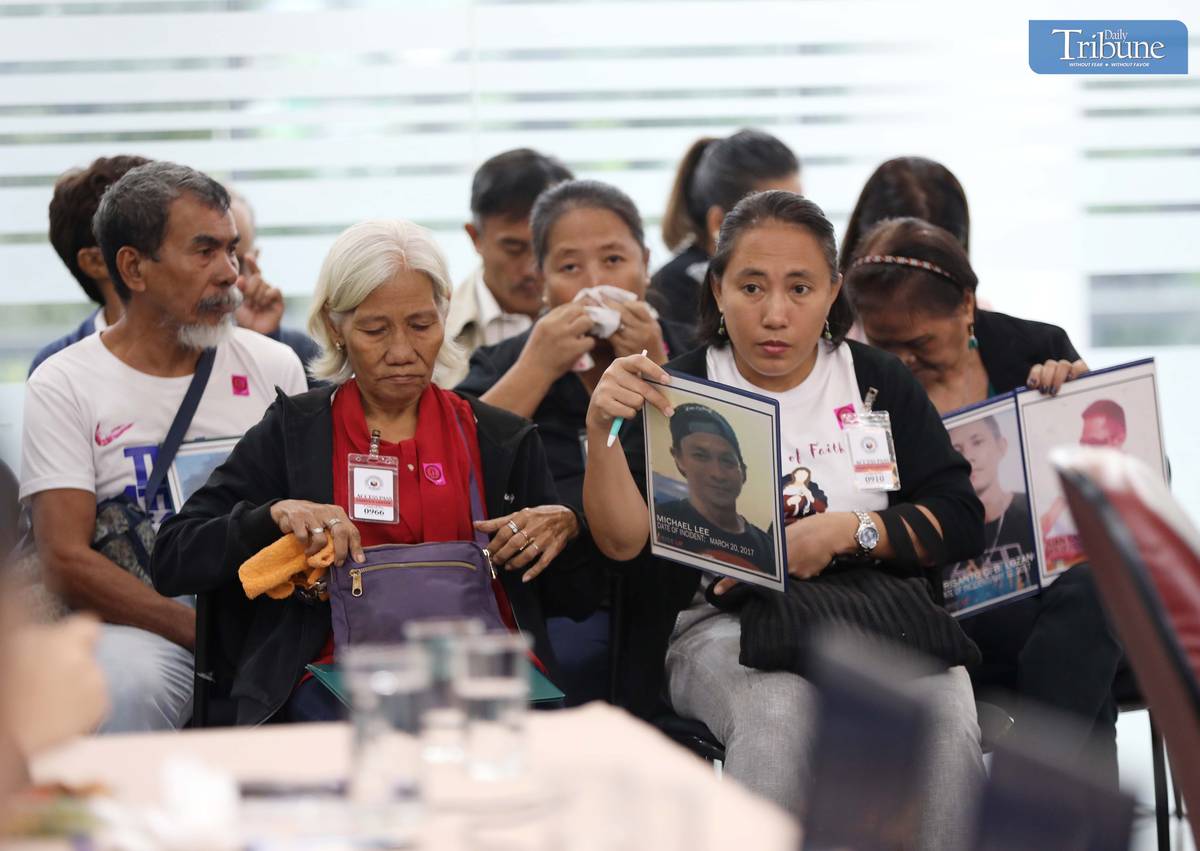 Families of drug war victims at Quad Comm hearing.