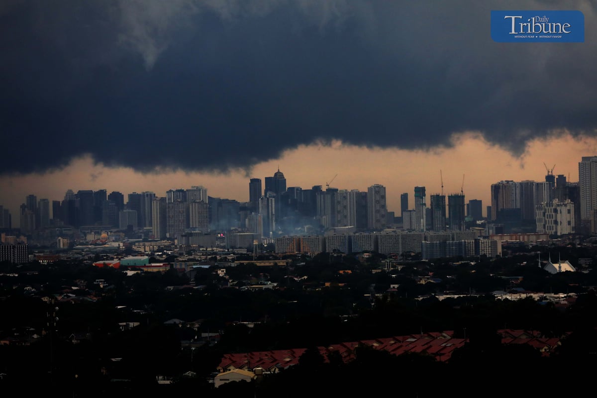 Dark clouds cover Metro Manila ahead of Tropical Depression Kristine's landfall.