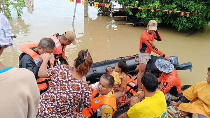 This handout photo taken and released yesterday by the Philippine Coast Guard shows residents affected by tropical storm ‘Kristine’ being evacuated from the roofs of their submerged houses in Libon town, Albay. Rescuers waded through chest-deep floodwaters to reach residents trapped by the storm, which has forced thousands to evacuate as it barrels towards the country's east coast.