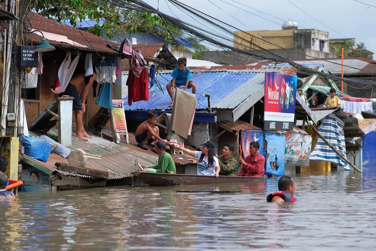 Hanging in there Trapped on their own roofs, residents in Naga, Camarines Sur await rescuers as floods submerge homes during heavy rains said to equal a month’s volume in a day. Philippine rescue workers battled floodwaters on 25 October to reach these residents as tropical storm ‘Trami’ (Kristine) moved out to sea after killing at least 40 people.