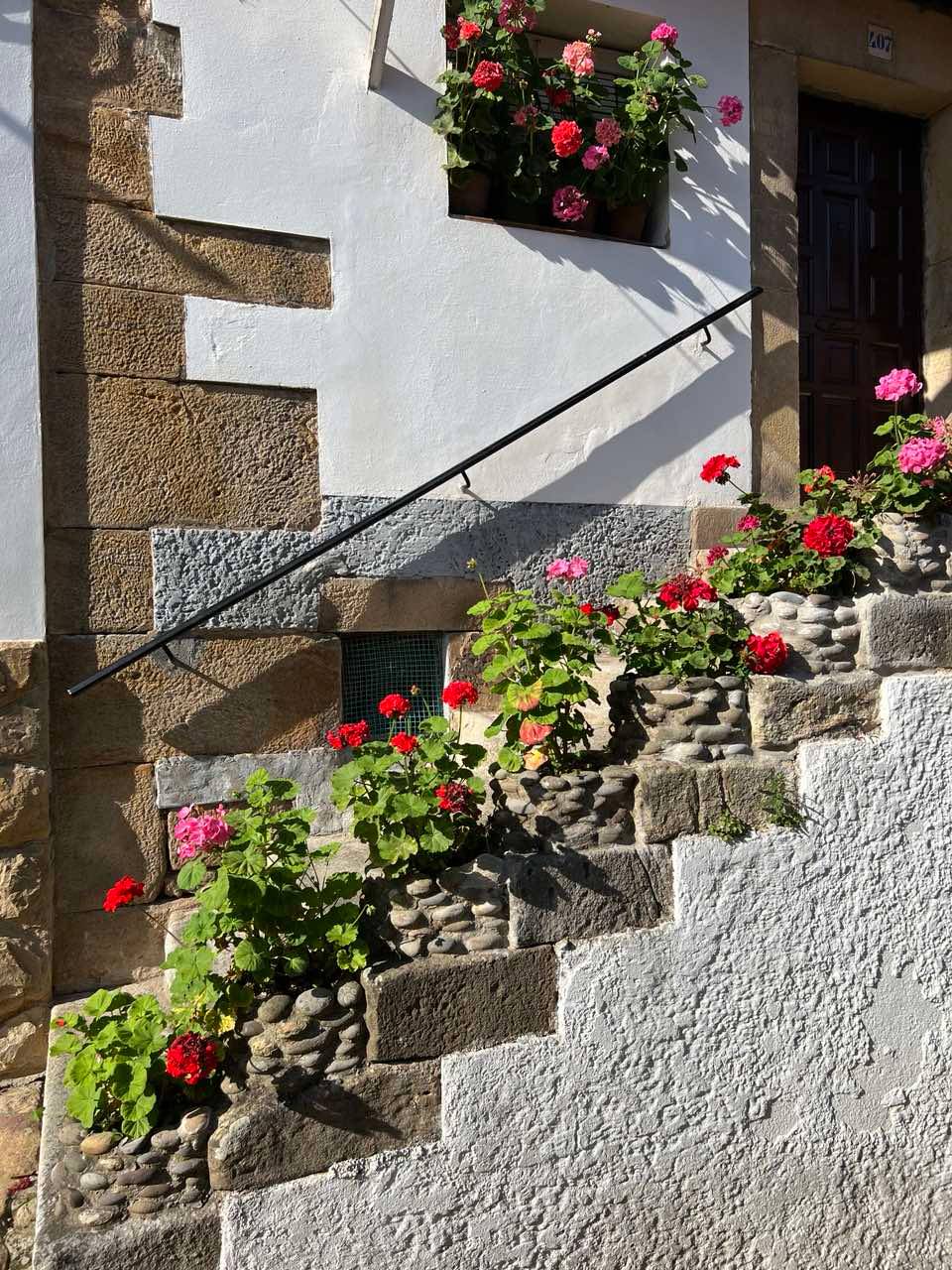 A quaint stairway lined with flowers