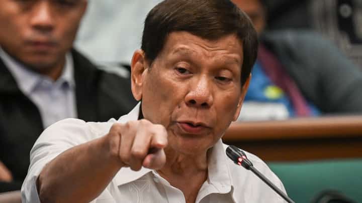 (FILE) Former Philippine president Rodrigo Duterte gestures as he attends a senate probe on the drug war during his administration, in Manila.