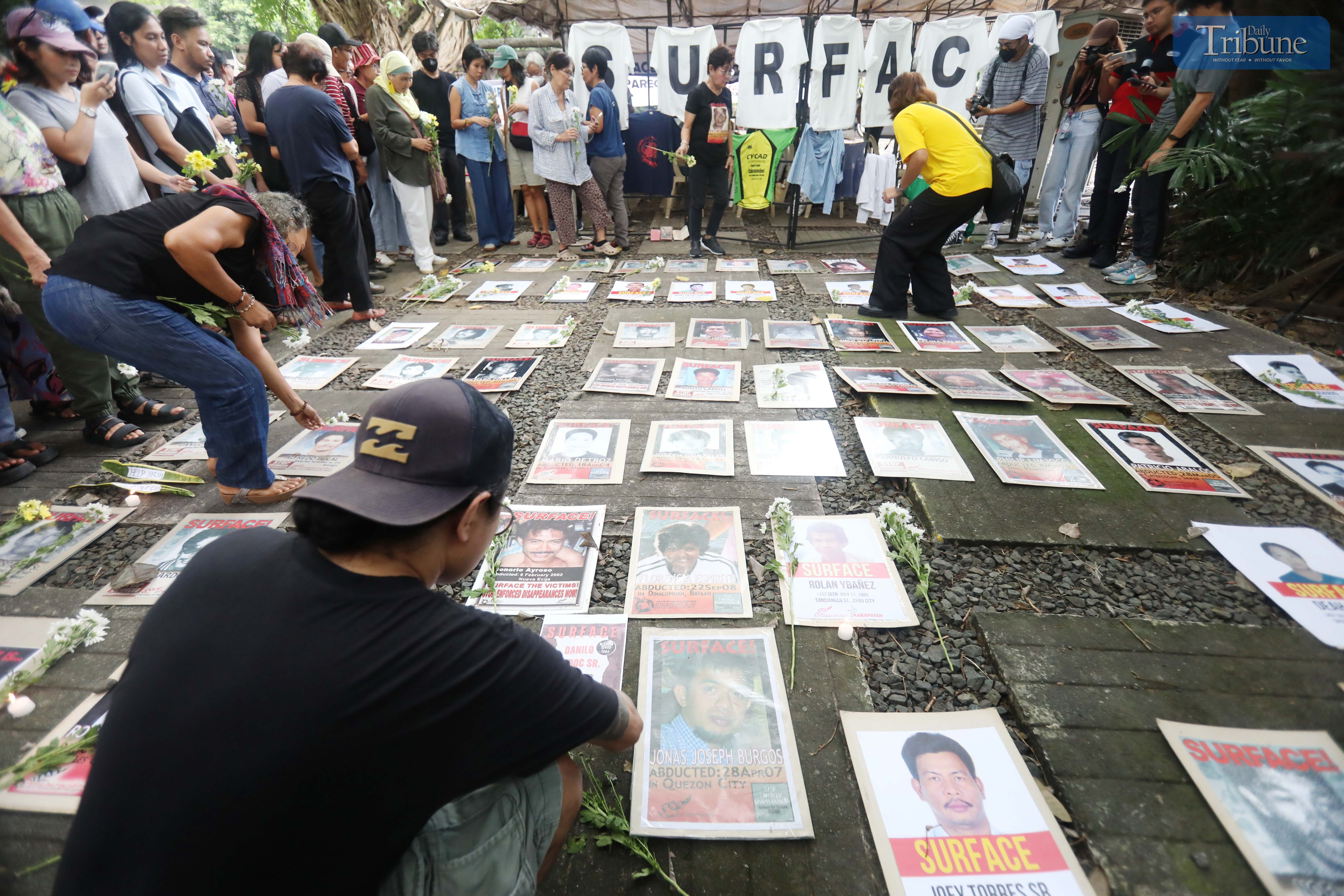 Families of Desaparecidos commemorate the victims of enforced disappearances with flowers and candles on All Souls Day, Saturday, 2 November 2024, at the Bantayog ng mga Bayani in Quezon City.