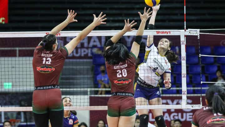 BELLA Belen of the NU Lady Bulldogs attacks the defense of Sam Ildefonso of the UP Fighting Maroons during their Shakey’s Super League Collegiate Pre-season Championship game late Sunday.