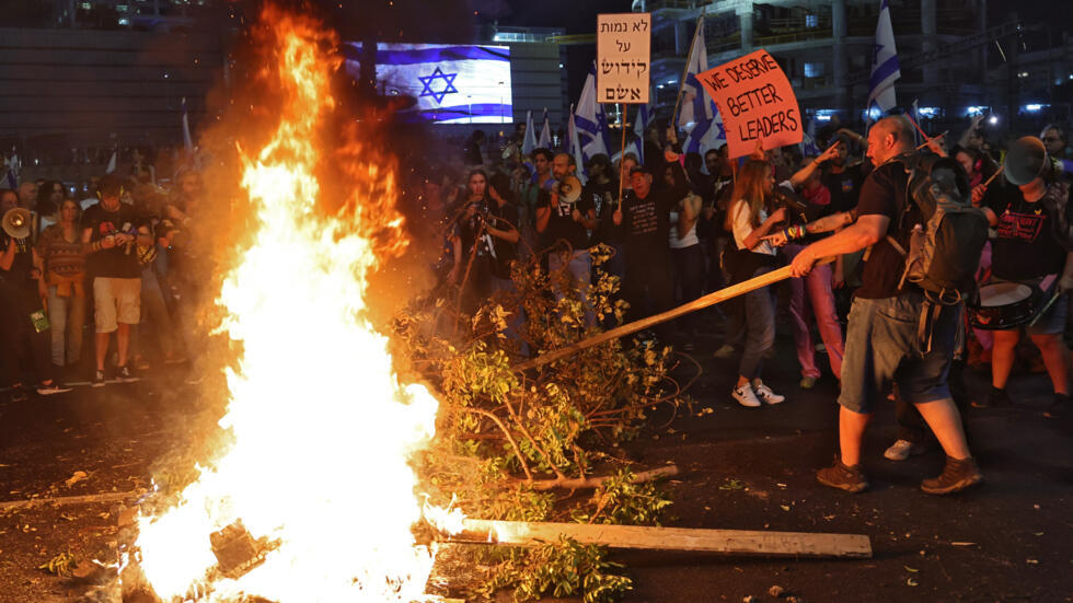 Thousands in Israel protest sacking of defense minister