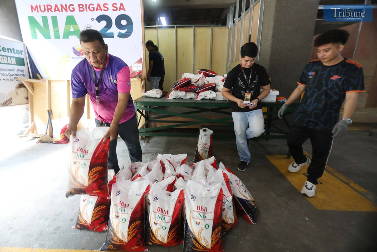 People purchase 10 kilos of rice at 29 pesos per kilo at the National Irrigation Administration (NIA) Kadiwa store in Quezon City.