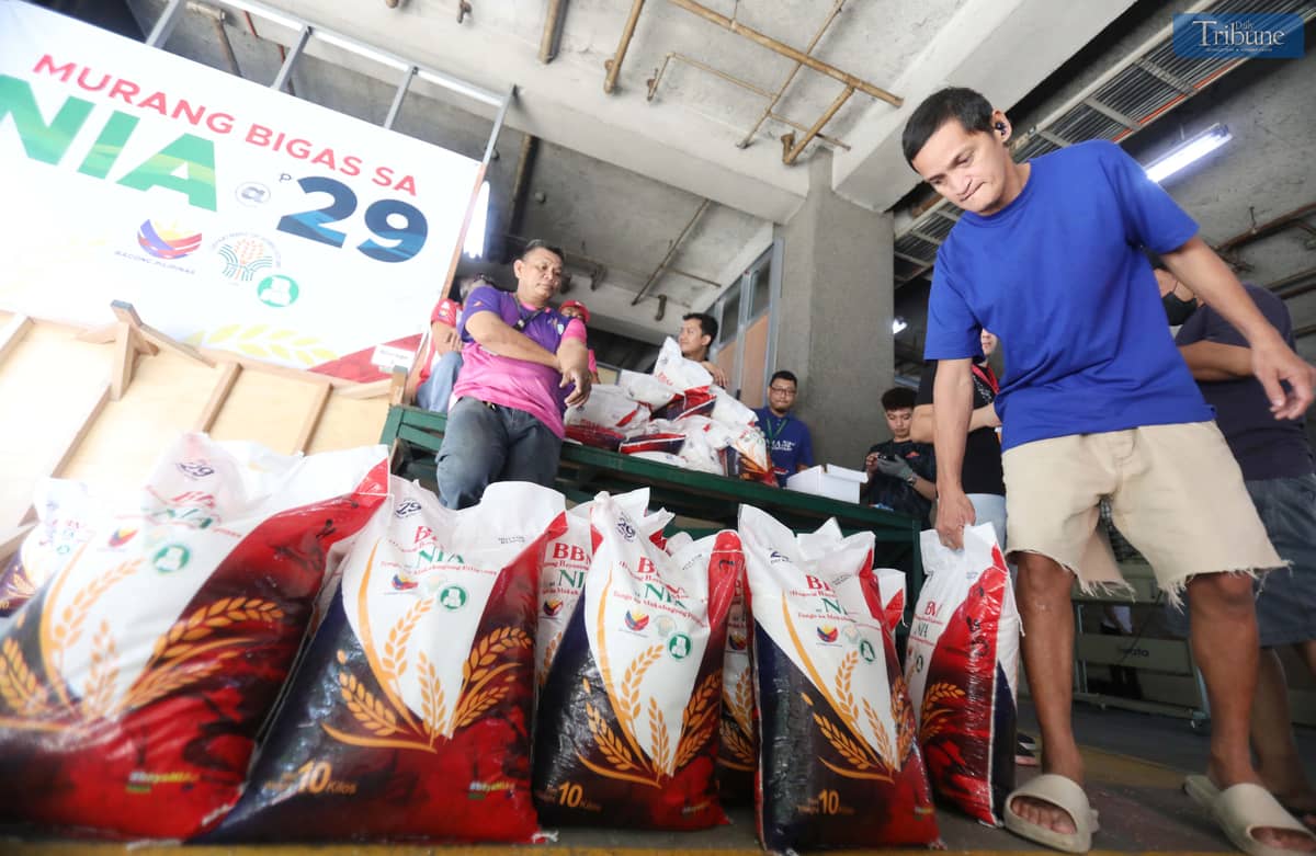 People purchase 10 kilos of rice at 29 pesos per kilo at the National Irrigation Administration (NIA) Kadiwa store in Quezon City.