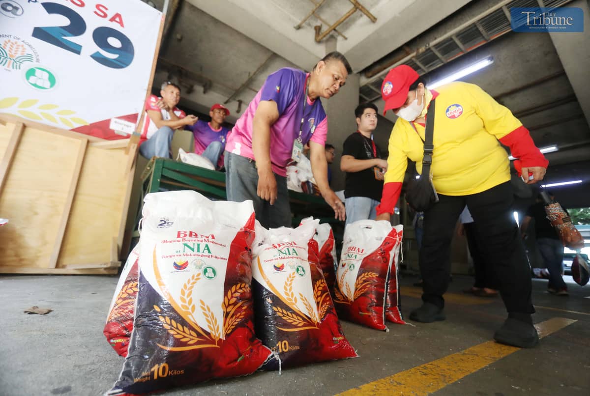 People purchase 10 kilos of rice at 29 pesos per kilo at the National Irrigation Administration (NIA) Kadiwa store in Quezon City.