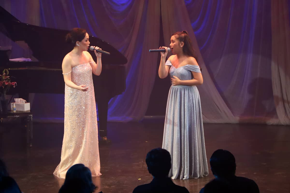 Mother sings on stage with daughter Simone Martinez.