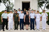 U.S. Ambassador MaryKay Carlson joins service members from different nations to honor veterans at the Manila American Cemetery.