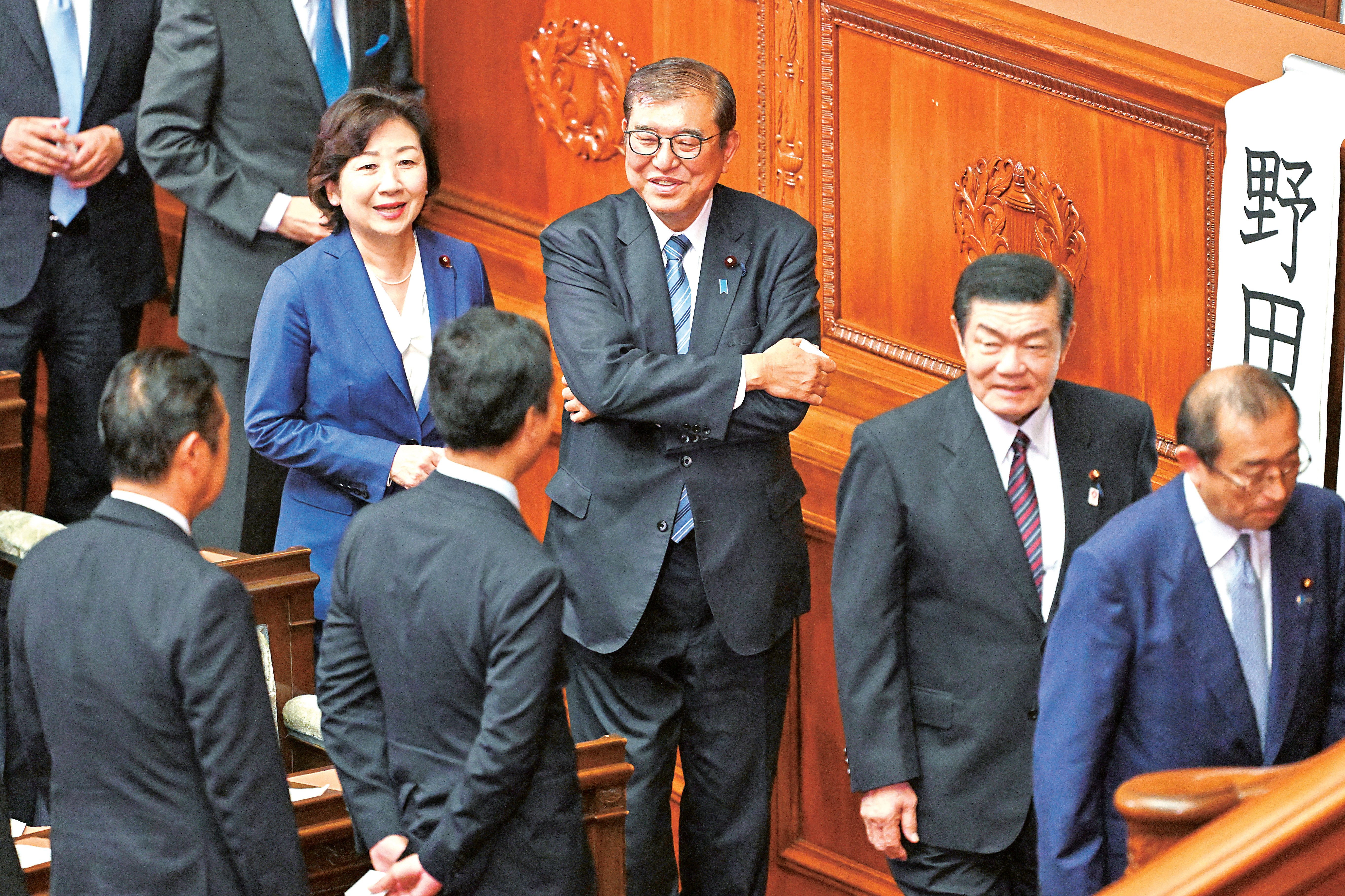 Japan’s Prime Minister Shigeru Ishiba (center) queues up to cast his vote in the second round of a parliamentary vote to nominate a prime minister following the 27 October general election during a special session of parliament in Tokyo.