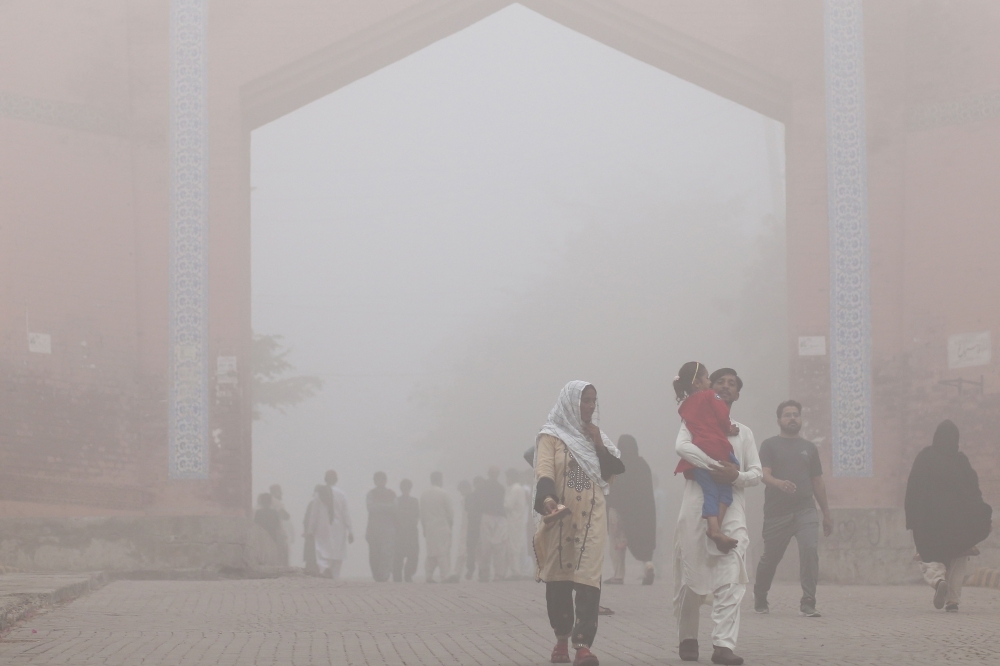Visitors walk out from the Bhumi Fort amid heavy smoggy conditions in Multan on November 9, 2024. Pakistan’s most populated province of Punjab ordered public spaces closed in smog-hit main cities, authorities said on November 8, as the country battles record air pollution.