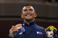 Bronze medallist Philippines' Eumir Marcial celebrates on the podium during the medal ceremony for the men's middle (69-75kg) boxing final bout during the Tokyo 2020 Olympic Games at the Kokugikan Arena in Tokyo on August 7, 2021.