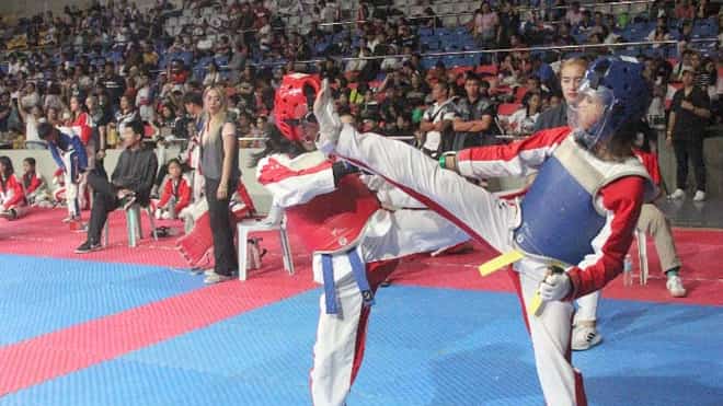 A player in a blue armor executes a head kick to her opponent during a previous sparring session supervised by the Philippine Taekwondo Association.